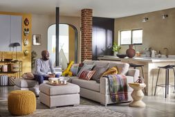 Ben Anderson on the Spinn left hand facing chaise sofa in Latte