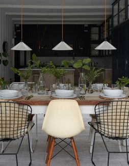 White glass Hay pendant lights over a kitchen table
